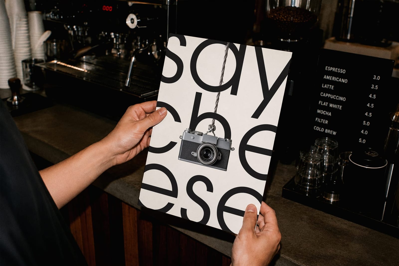 Hand Holding Poster Mockup Coffee Shop Interior Scene 