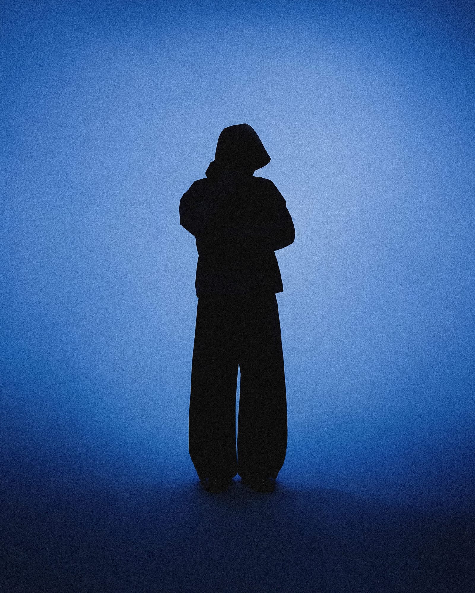 Lone Figure In A Blue Lit Studio