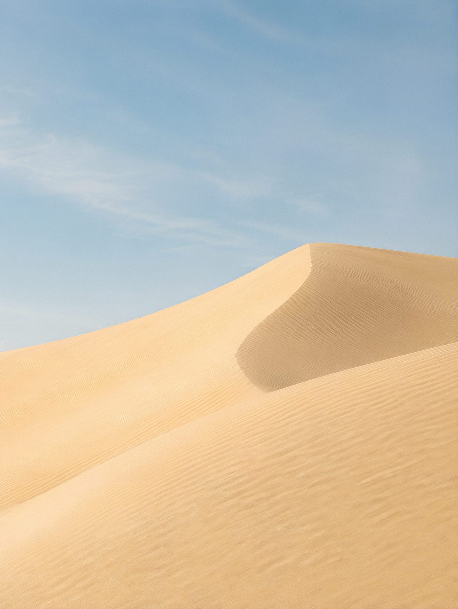 Serene Desert Dunes Under A Soft Sky