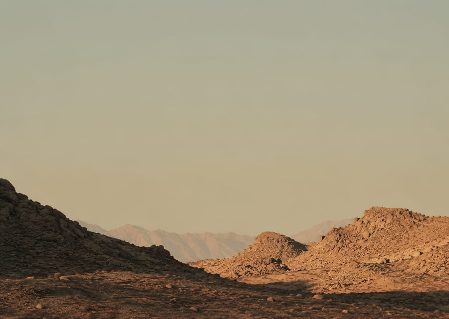 Golden Hour Desert Landscape With Rocky Hills