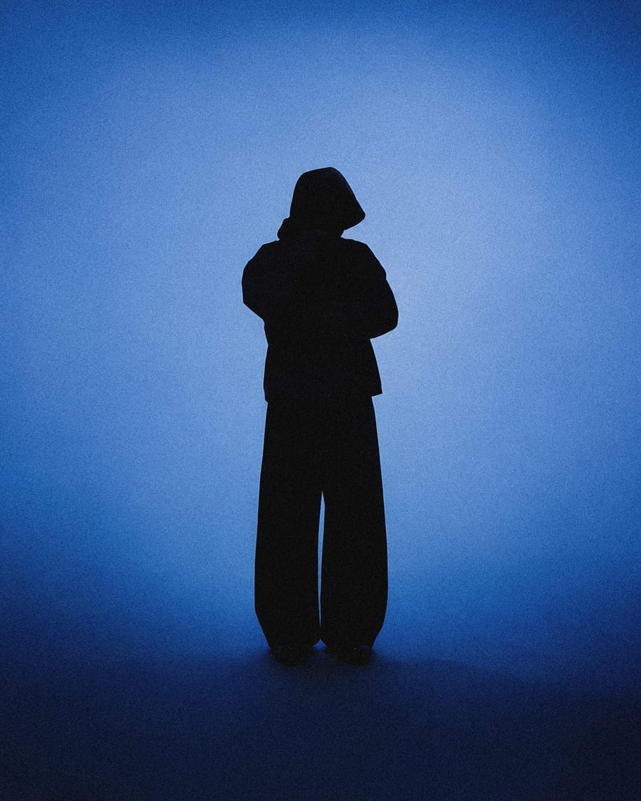 Lone Figure In A Blue Lit Studio